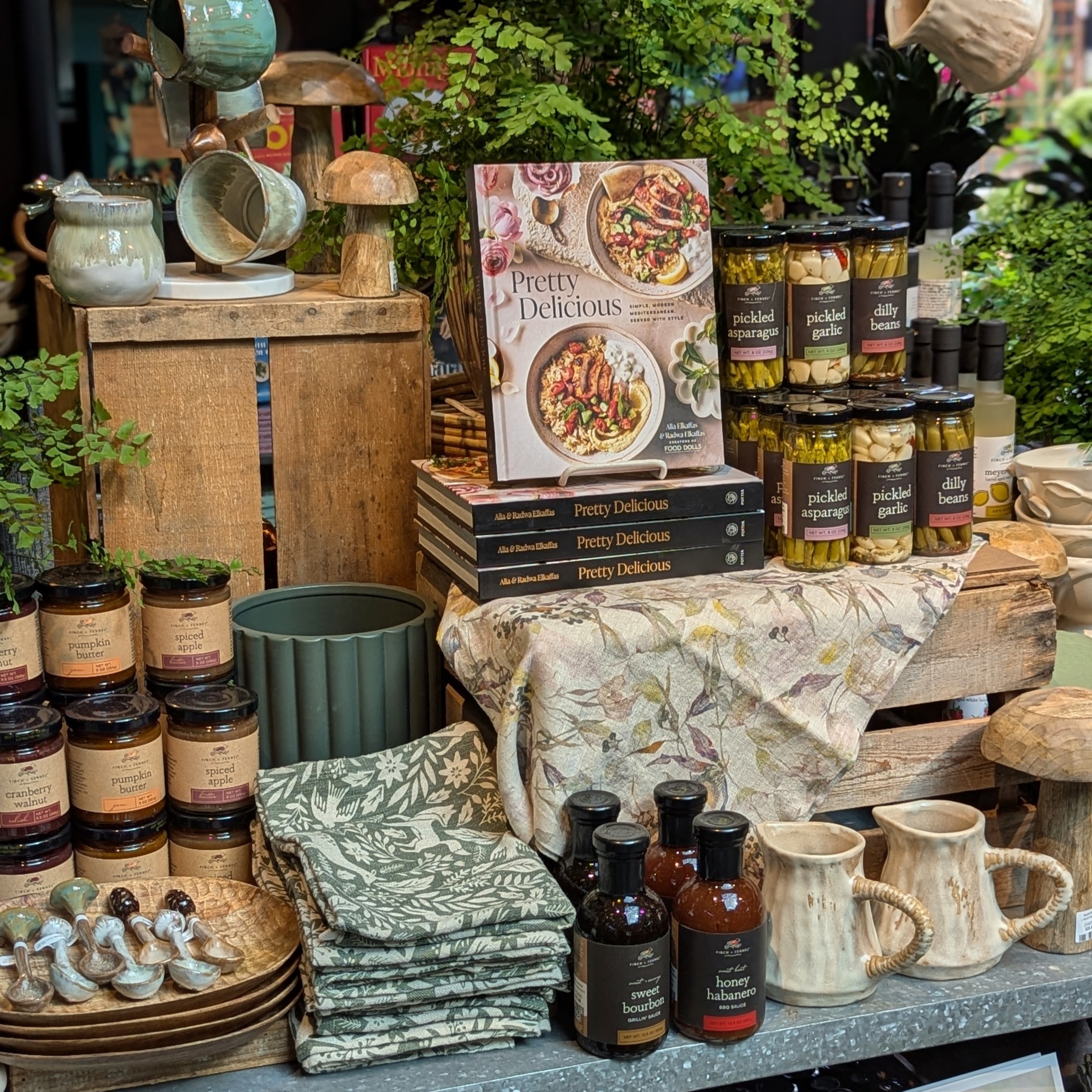 An assortment of cookbooks, kitchen towels, spices and sauces available at Ravenna Gardens